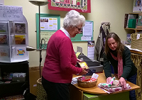 Fairtrade shop customer being served at the counter